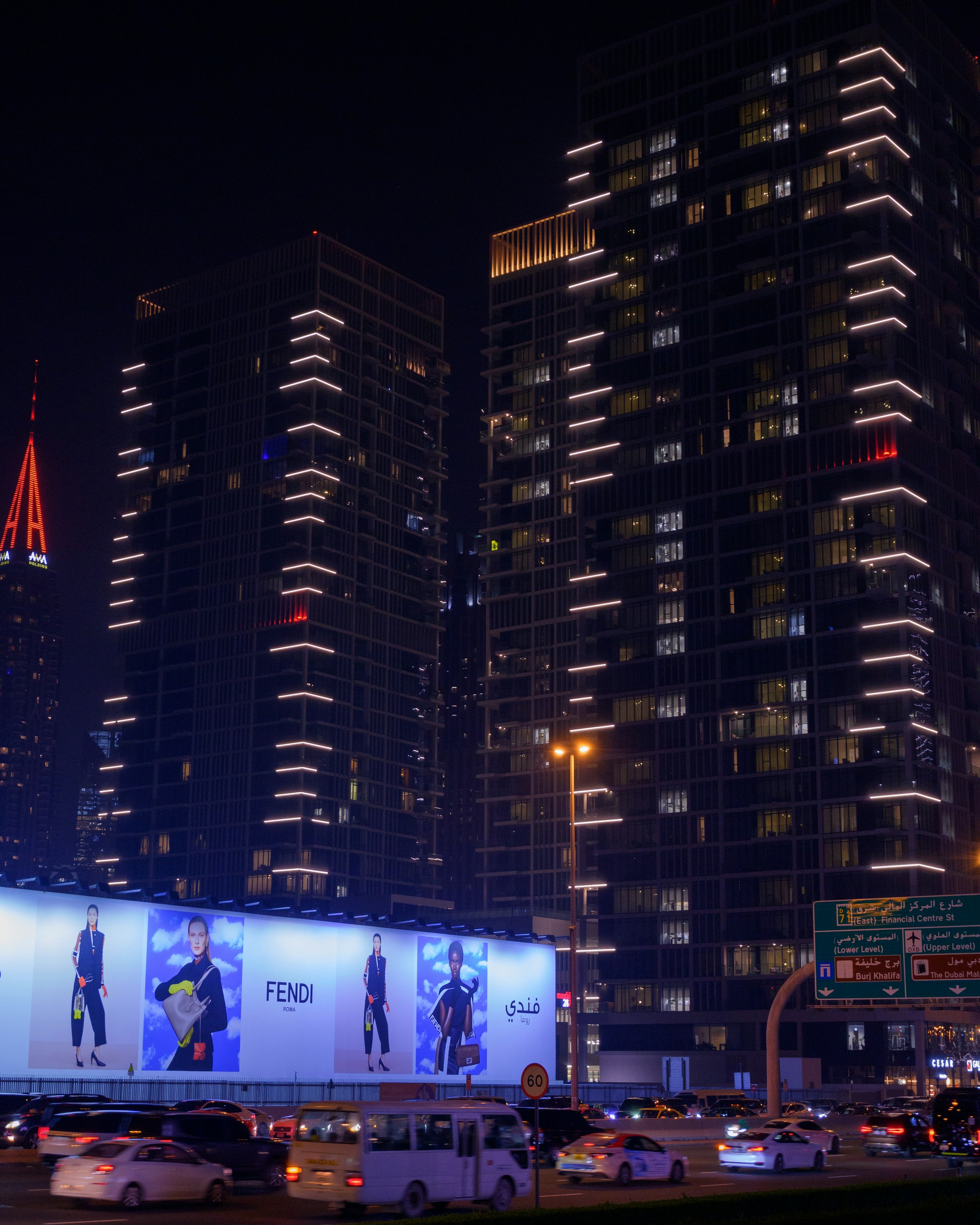 Large-format digital out-of-home media illuminating a Dubai city street
